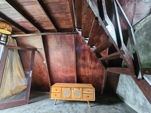 a room with a wooden cabinet and a ceiling at UmaUthu Bali in Tabanan
