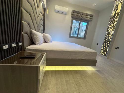 a bedroom with a bed and a desk in it at MidtownTahrirViewSuites in Cairo