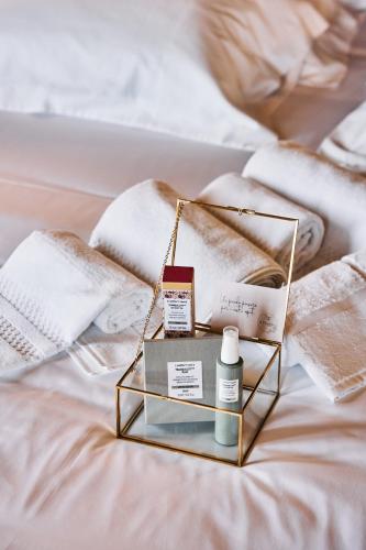 a bed with a tray with products on it at Tenuta Il Poggio - Luxury B&B in Felegara