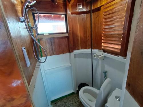 a bathroom with a toilet and a shower at Open Trip Komodo 3D2N in Labuan Bajo