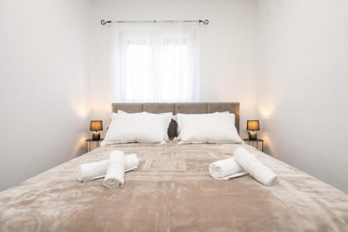 a bedroom with a large bed with white pillows at Apartment MM in Sukošan