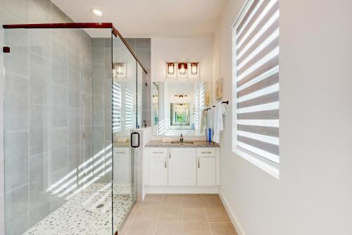 a bathroom with a shower and a sink at Cove House in Matlacha