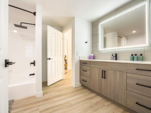 a bathroom with a sink and a mirror at CozySuites Oasis at Kierland Commons in Scottsdale