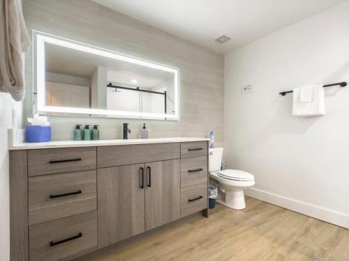 a bathroom with a sink and a toilet at 2BR Kierland Commons Golf Oasis by CozySuites! in Scottsdale