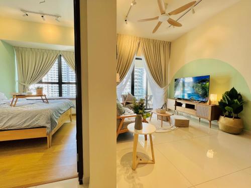 a living room with a bed and a tv at Muji-Inspired 2BR 2BA Apartment, 8 Mins to CIQ, Sleeps 2-6 in Johor Bahru
