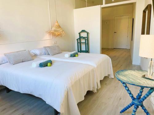 a bedroom with two beds and a table with a lamp at COLLECTION PORT - B&B Boutique , Alicante Center in Alicante