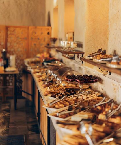 a buffet line with many different types of food at Seki Cave Suites in Goreme