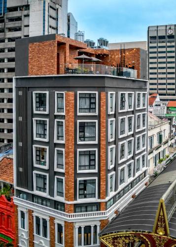 a tall building with white and red brick at Santa Grand Classic Kuala Lumpur, Chinatown in Kuala Lumpur