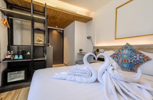 a bedroom with white towels on a bed at Santa Grand Classic Kuala Lumpur, Chinatown in Kuala Lumpur