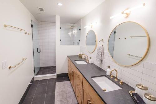 a bathroom with two sinks and two mirrors at 128 Union in Traverse City