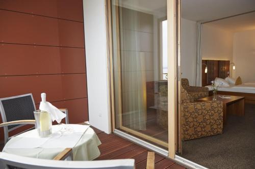 a room with a table and a room with a bedroom at Flair Hotel zum Schiff in Meersburg
