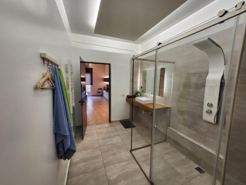 a bathroom with a walk in shower and a sink at Luxury Apartment Acropolis Syggrou in Athens
