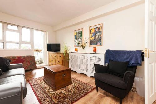a living room with a couch and a chair at Central Camden Flat With Terrace For 4 People in London