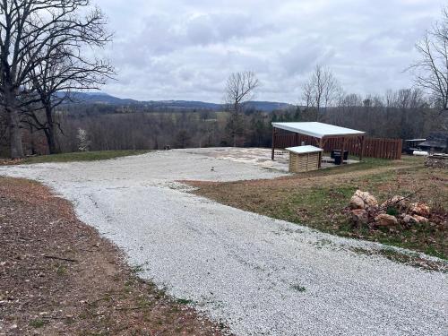 a gravel road with a pavilion in a field at The Best Buffalo River RV Campsite in Hasty