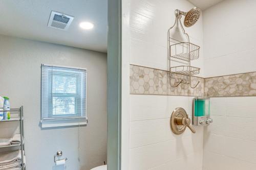 a bathroom with a shower with a toilet and a window at Cozy Estes Park Condo with Balcony and Fireplace! in Estes Park