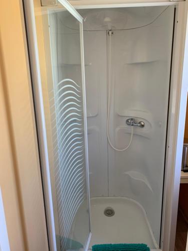 a shower with a glass door in a bathroom at Camping La Saline d'Arc et Senans in Arc-et-Senans