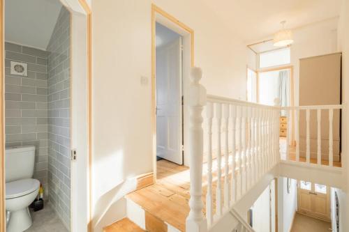 a bathroom with a staircase leading to a toilet at Beautiful and Spacious Cambridge Home with Free Parking & Garden! in Cambridge
