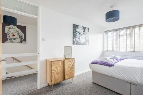a bedroom with a bed and a walk in closet at Charming Renovated Family Home in Cherry Hinton
