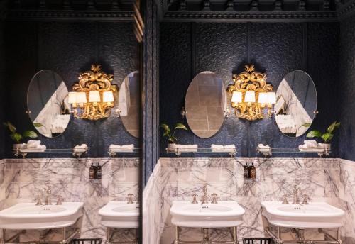 a bathroom with four sinks and mirrors on the wall at Juliana Hotel & Spa - Brussels Centre in Brussels