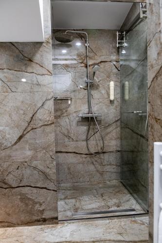 a shower with a glass door in a bathroom at Agora Boutique Hotel in Sofia
