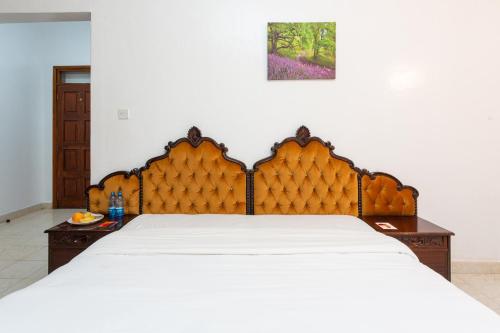 a bedroom with a large bed with white sheets at Bonsai Villa in Nairobi
