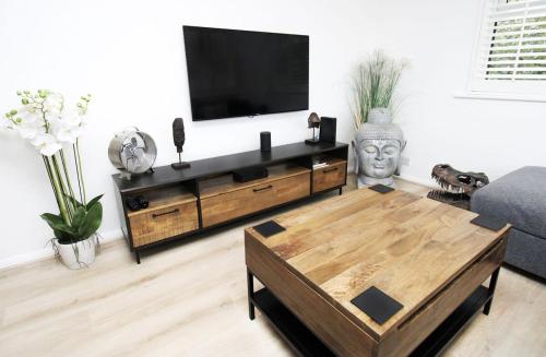 a living room with a tv and a coffee table at Modern and Cosy Flat For 4 in Cherry Hinton