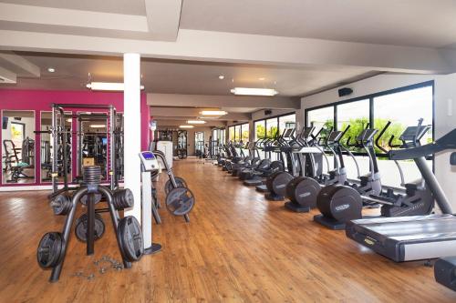 a gym with a row of treadmills and cardio machines at Papagayo Beach Hotel in Willemstad