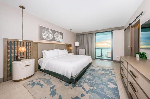 a bedroom with a large bed and a large window at 1612 - Beachfront Condo in Clearwater Beach