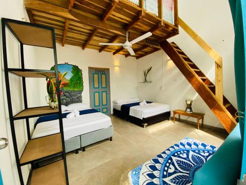 a bedroom with two beds and a loft at AFRA Reserva Natural in Santa Marta