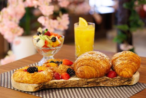 a tray of croissants and fruit on a table at DoubleTree by Hilton London Angel Kings Cross in London