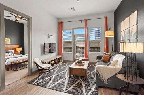 a living room with a couch and a bed at Modern Town Lake CozySuites in Tempe