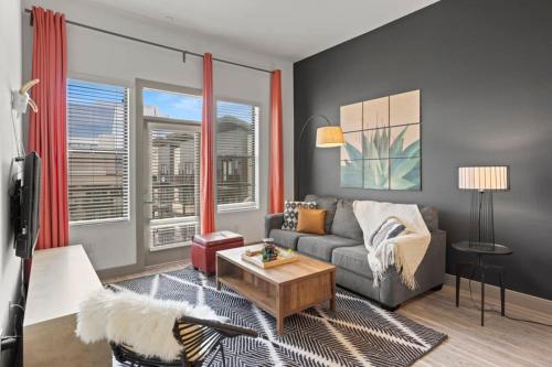 a living room with a couch and a table at Modern Town Lake CozySuites in Tempe