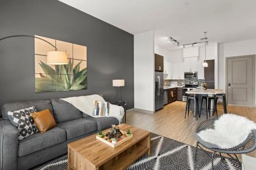 a living room with a couch and a table at Modern Town Lake CozySuites in Tempe