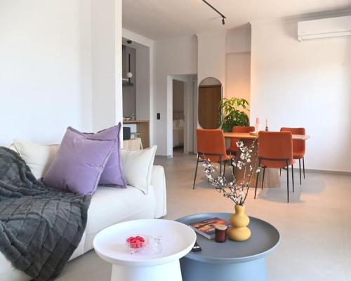 a living room with a white couch and a table at OpenSea in Chalkida