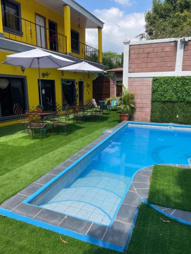 a swimming pool in the yard of a house at Hotel Boutique Casa D' Luna in Choluteca