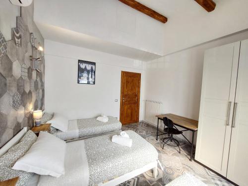 a small bedroom with two beds and a desk at Veracini apartment in Florence