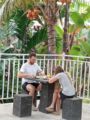 a man and a woman sitting at a table at Power Zone Guest House in Matale
