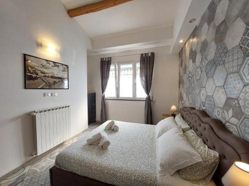 a bedroom with a bed with a large headboard at Veracini apartment in Florence