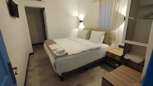 a bedroom with a white bed in a room at The Professor's Hotel in Bodrum City