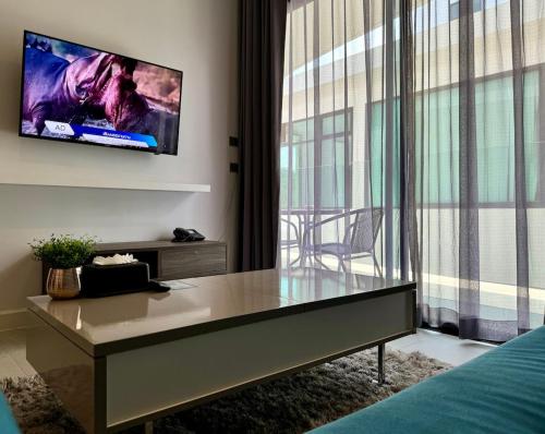a bedroom with a table and a tv on the wall at Utopia - the best condo project at Naiharn in Rawai Beach