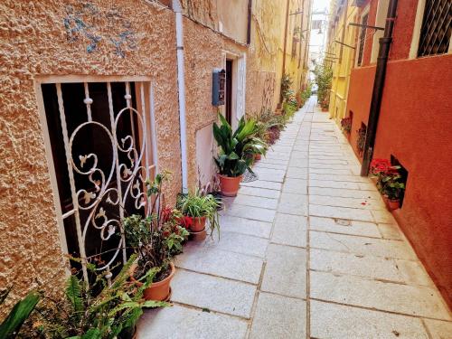 an alley with potted plants on the side of a building at Casa vacanza Castello in Cagliari