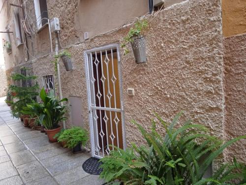 a brick building with a door and plants on it at Casa vacanza Castello in Cagliari