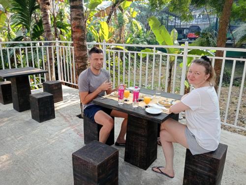 a man and a woman sitting at a table at Power Zone Guest House in Matale