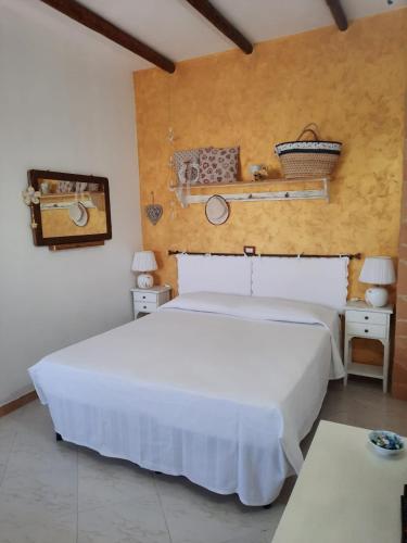 a bedroom with a large white bed in a room at Camera Sole in Alghero