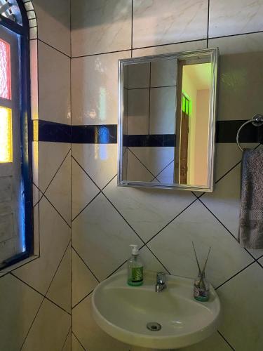 a bathroom with a sink and a mirror at Pousada do Tom in Lençóis