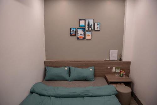 a small bedroom with a bed and a table at Halidao Homestay in Hai Phong