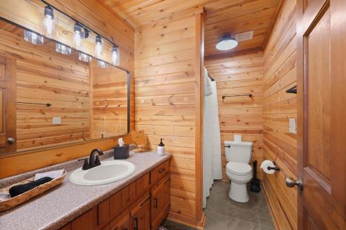 a bathroom with a toilet and a sink at Firefly Lodge - Cozy 4 bedroom cabin minutes to Helen in Sautee Nacoochee