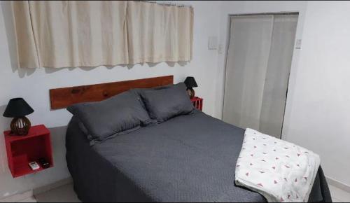 a bedroom with a bed and a window at Estúdios Mangueiras in Florianópolis