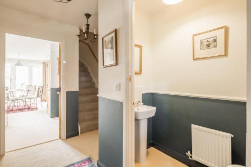 a bathroom with a toilet and a sink at Stunning 3 Bedroom Home with Terrace & Parking in Trumpington