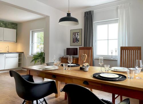 a dining room with a wooden table and chairs at Haus Silberberg in Haslach im Kinzigtal